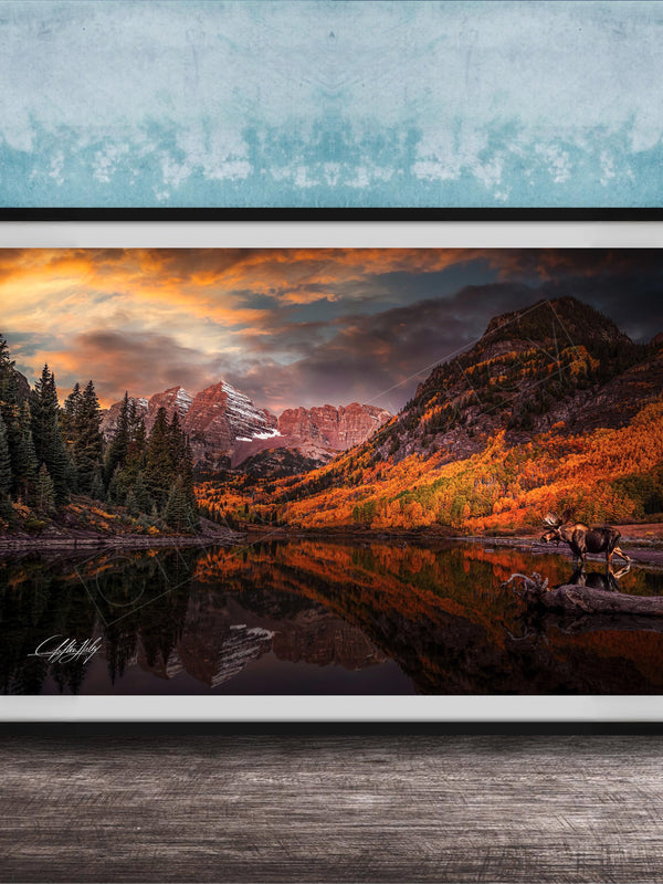 a serene mountain landscape with a lake reflecting the vibrant colors of the sky and surrounding trees.