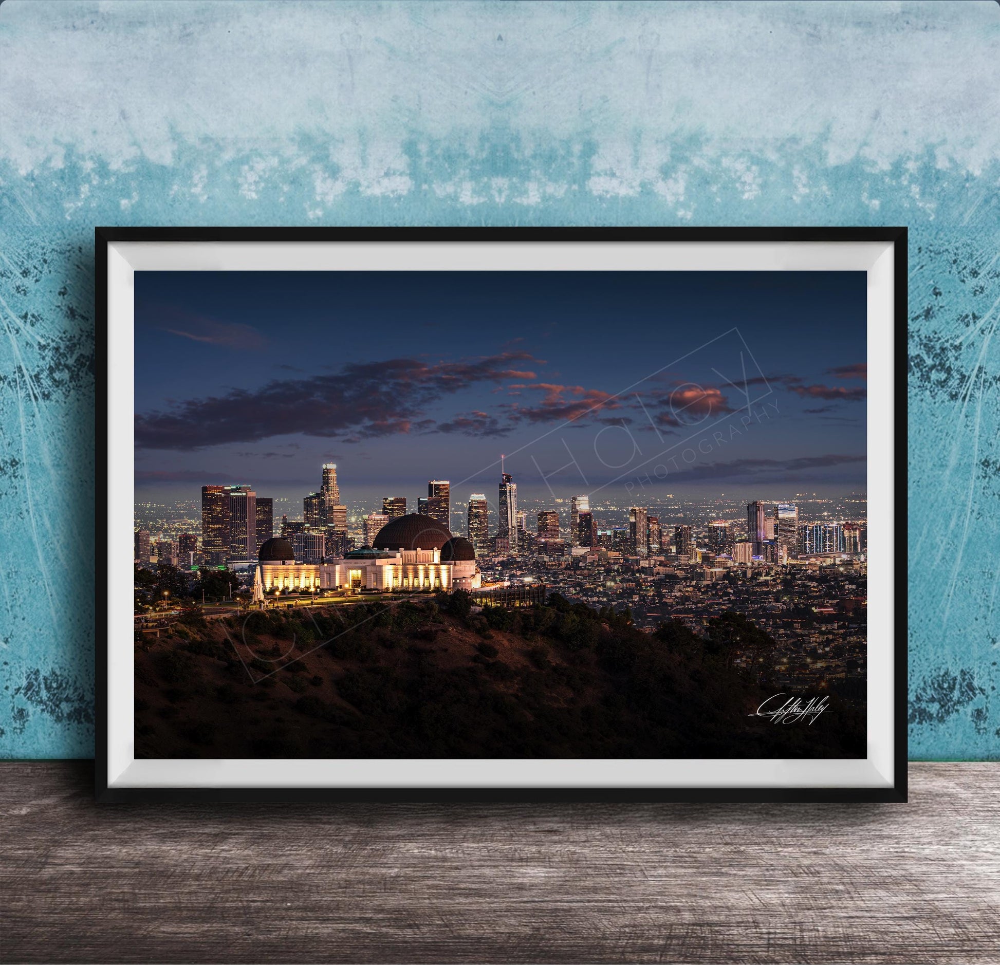 A framed photograph of the Los Angeles skyline at night, with the iconic Griffith Observatory prominently visible in the foreground.