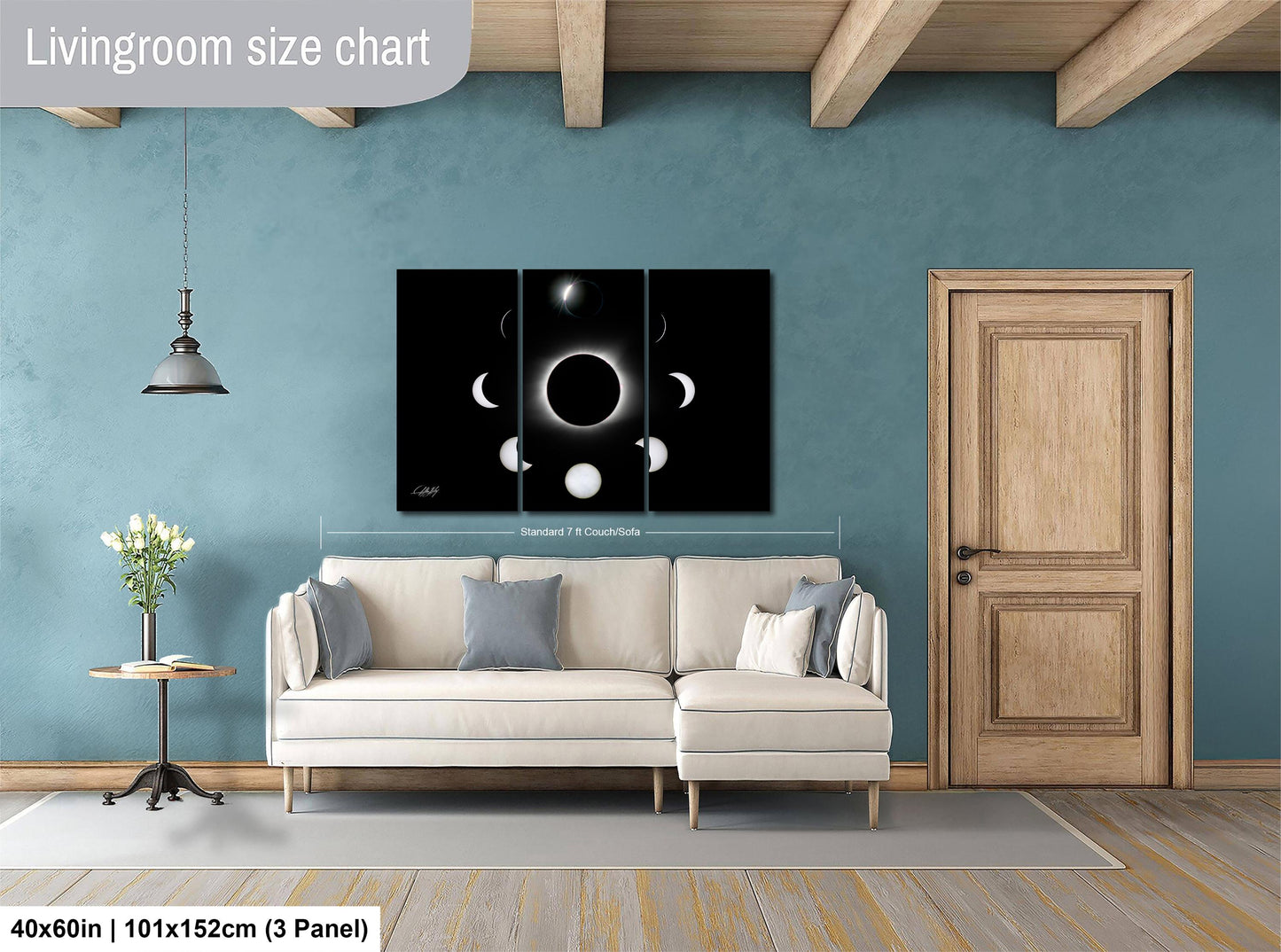 The image is a living room with a white sofa, a wooden door, and a large black and white solar eclipse artwork on the wall.