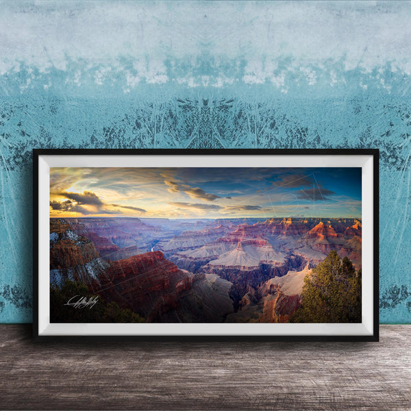 A framed photograph of the Grand Canyon, showcasing the vast and breathtaking landscape with its dramatic rock formations and vibrant colors at sunset.