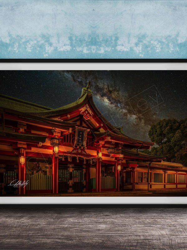 A framed photograph depicting a traditional Japanese temple at night, with a starry sky and a galaxy in the background.