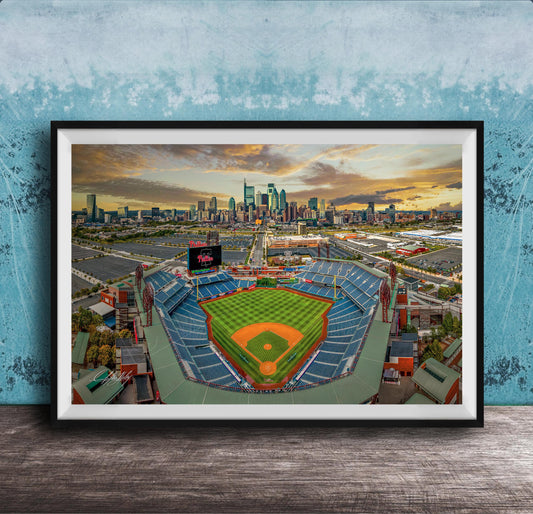 The image is a framed photograph of a baseball stadium in a city, with the city skyline visible in the background.