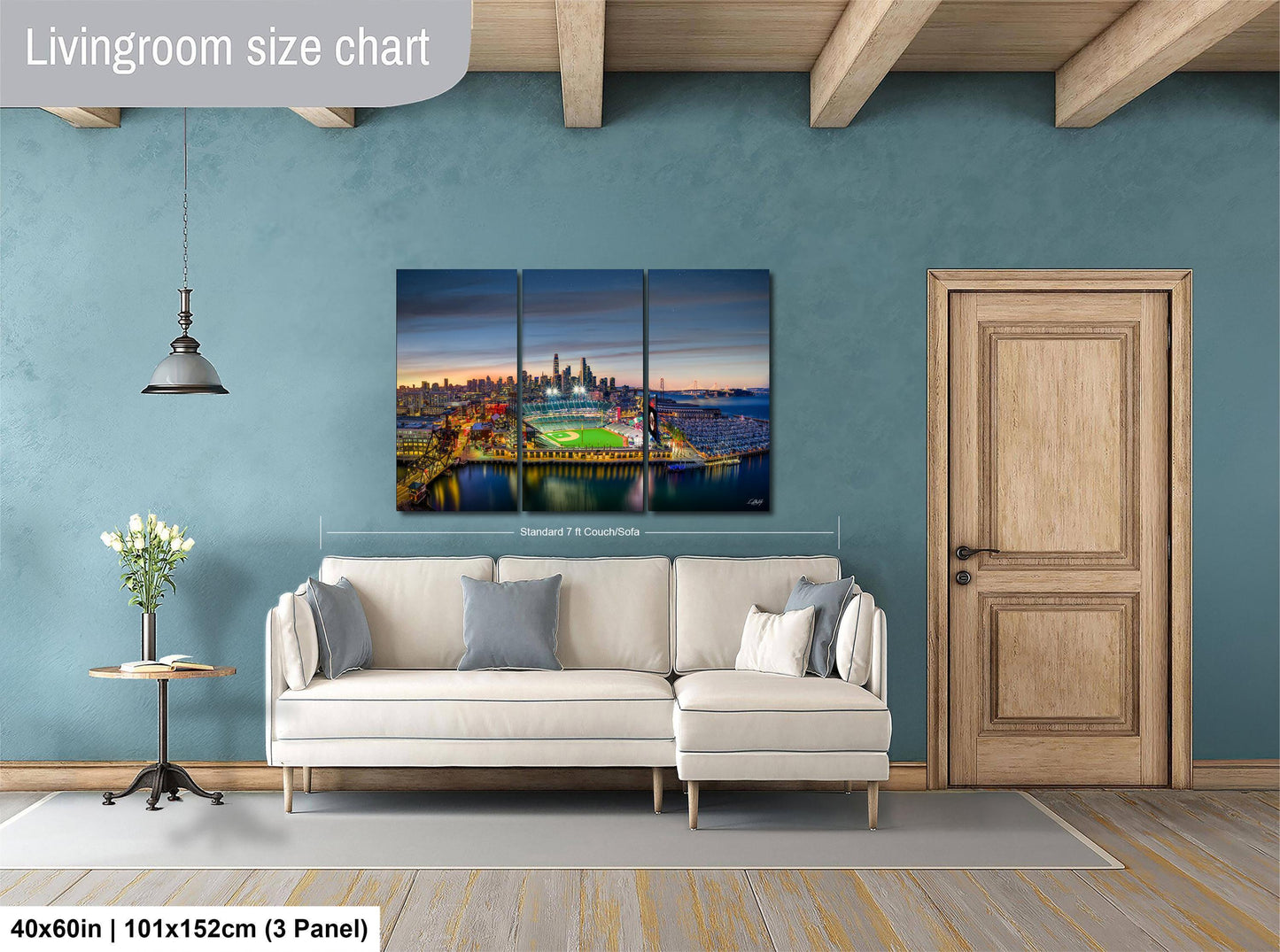 The image is a living room with a large, colorful cityscape painting hanging on the wall above a white sofa.