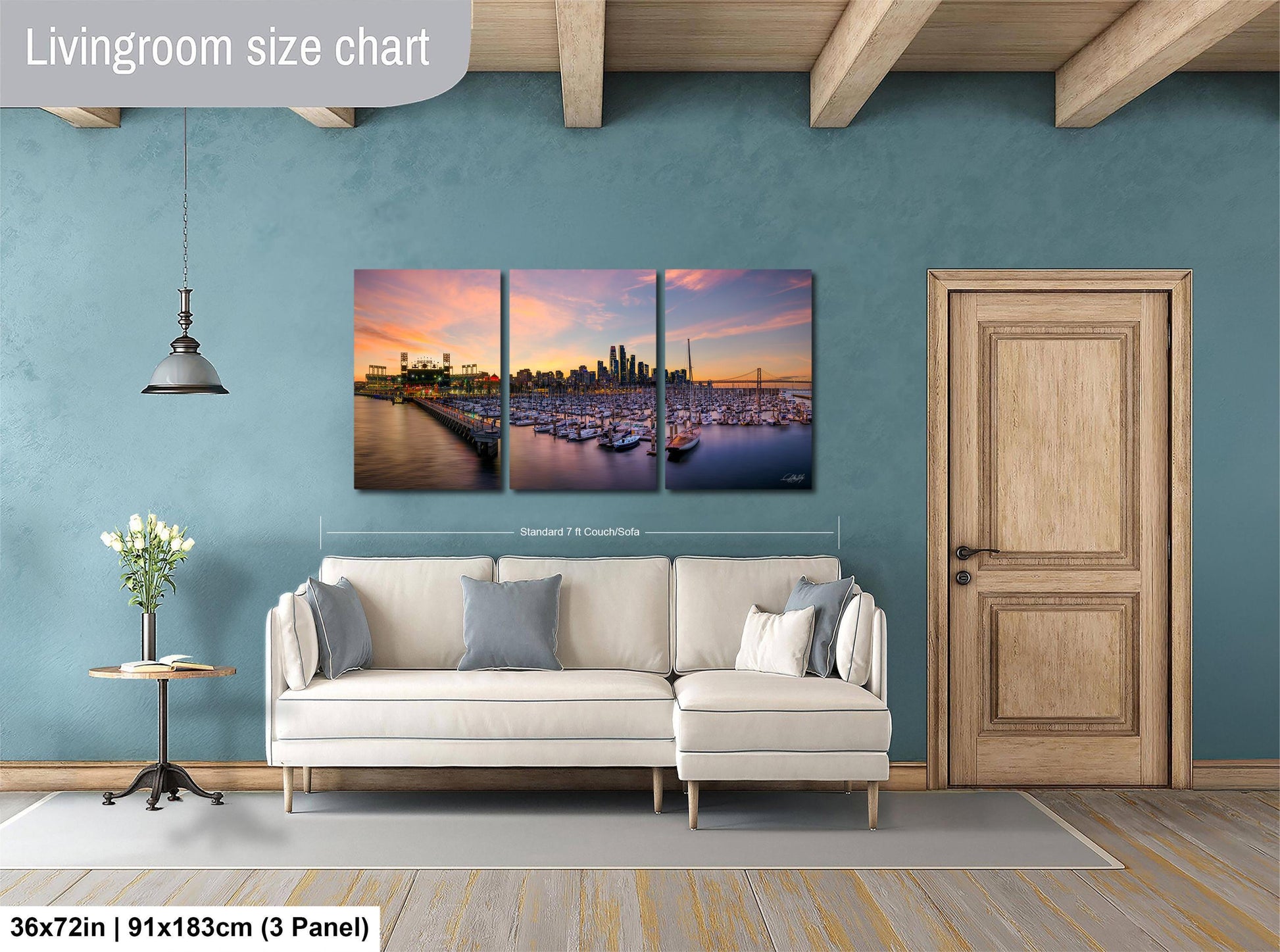 The image is a living room with a large, three-panel living room size chart on the wall. The chart displays the dimensions of the living room in both square feet and square meters. The living room is furnished with a white sofa and a wooden door, and there is a vase of flowers on a table nearby.