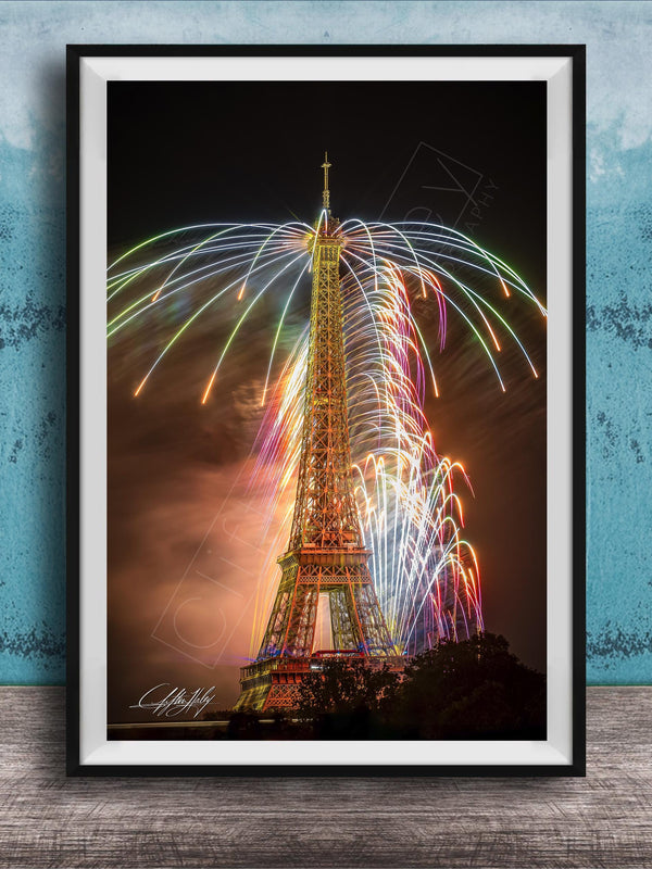 a tall, illuminated tower with a colorful display of fireworks in the sky, creating a vibrant and festive atmosphere.