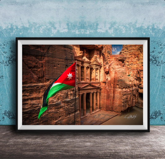 A framed photograph of the ancient ruins of Petra, Jordan, with the national flag of Jordan prominently displayed.