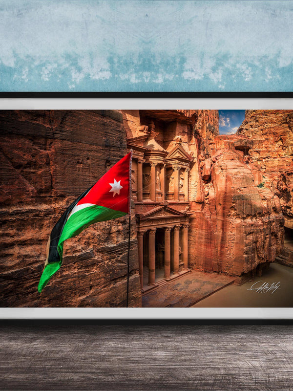 A framed photograph of the ancient ruins of Petra, Jordan, with the national flag of Jordan prominently displayed.