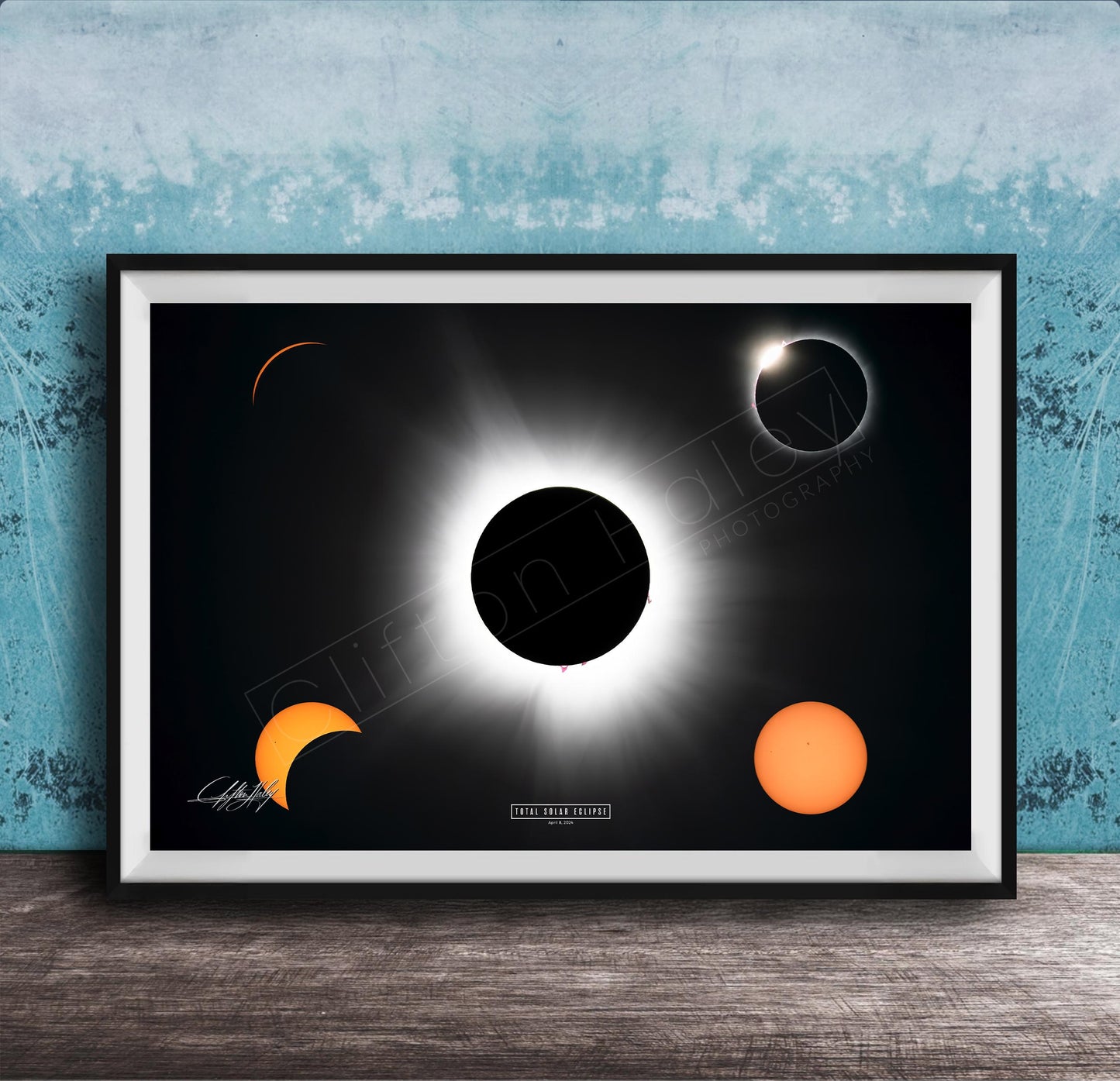 The image is a framed poster depicting a solar eclipse, with the moon partially obscuring the sun and the sun appearing as a bright white orb against the dark background.