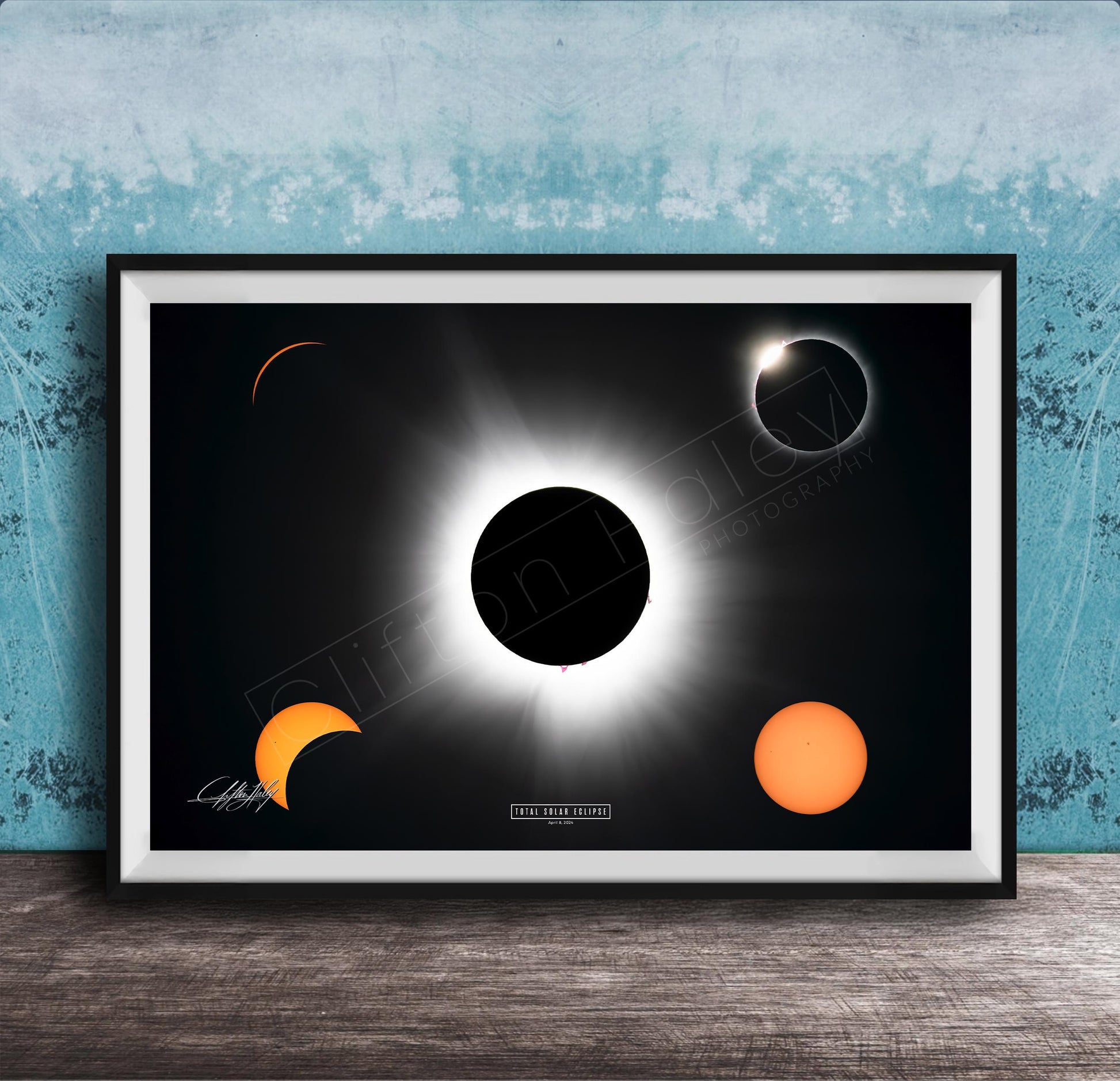 The image is a framed poster depicting a solar eclipse, with the moon partially obscuring the sun and the sun appearing as a bright white orb against the dark background.