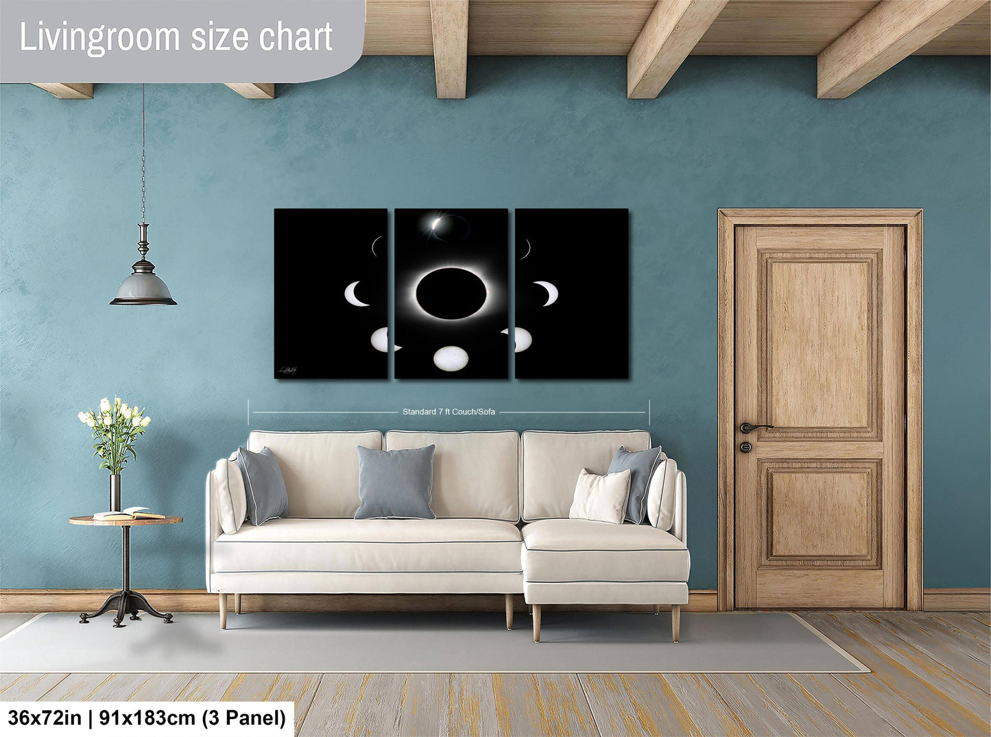 The image is a living room with a white sofa, a wooden door, and a large black and white solar eclipse artwork hanging on the wall.