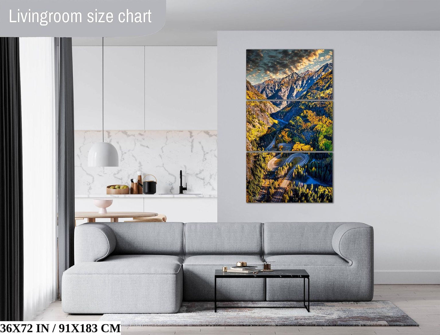 The image is a living room with a gray sofa, a coffee table, and a large wall art depicting a scenic mountain landscape.