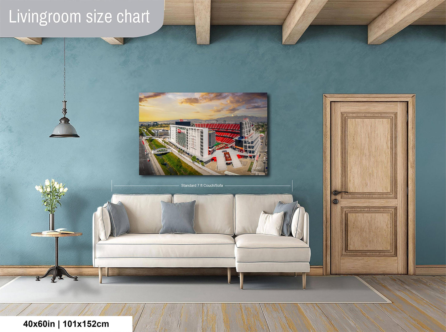 a living room with a large white sofa, a wooden door, and a painting of a cityscape hanging on the wall.