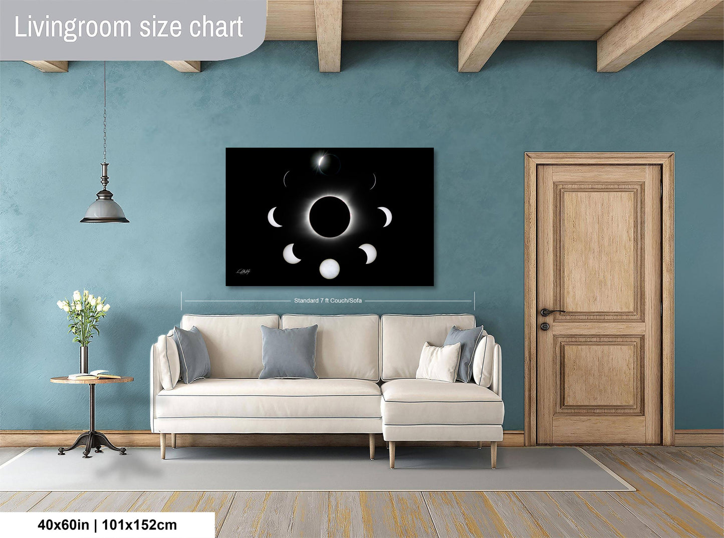 a living room with a white sofa, a wooden door, and a large black and white poster of the phases of the moon hanging on the wall.