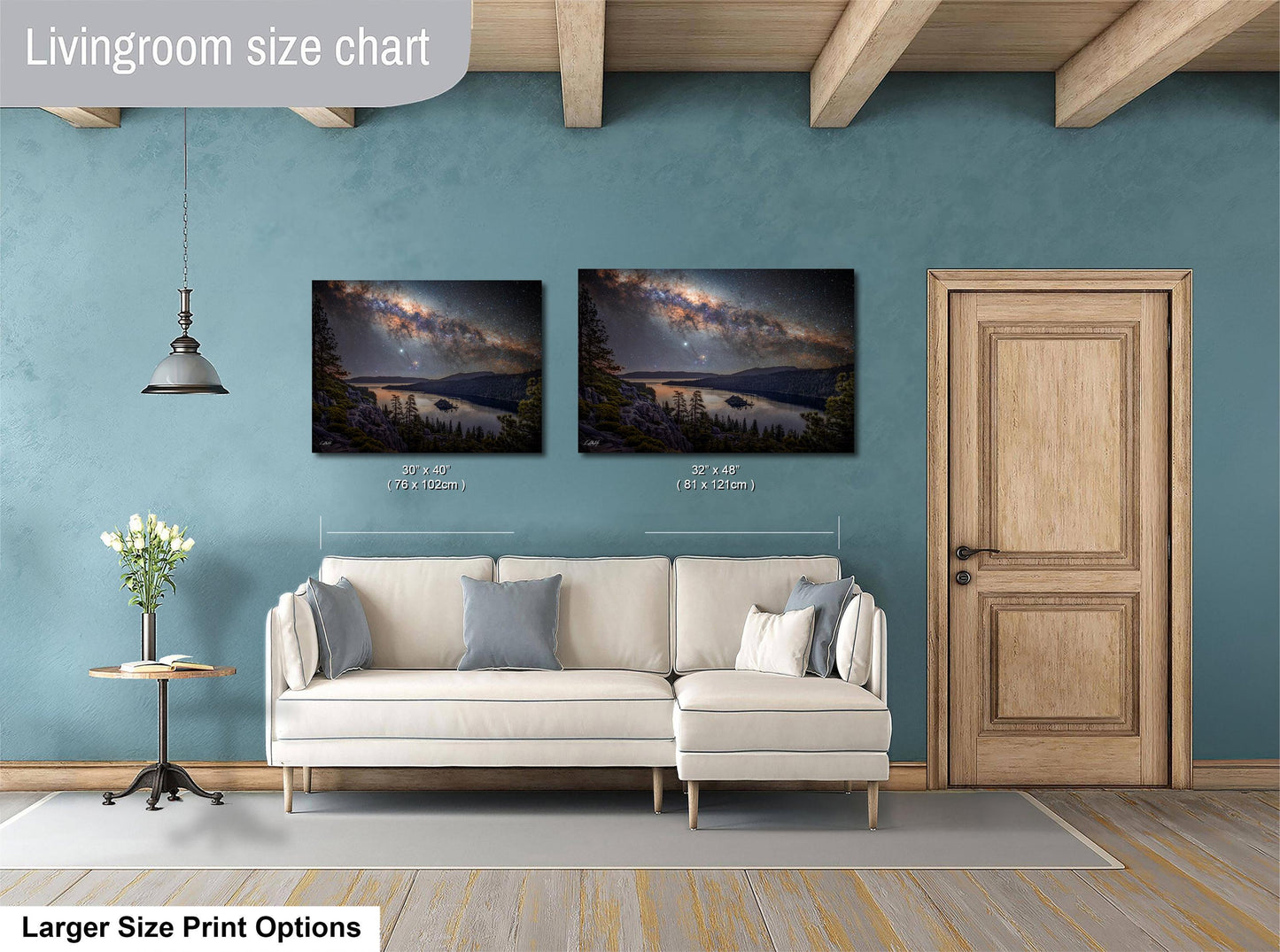 a living room with a white sofa, a wooden door, and two framed landscape paintings hanging on the wall.
