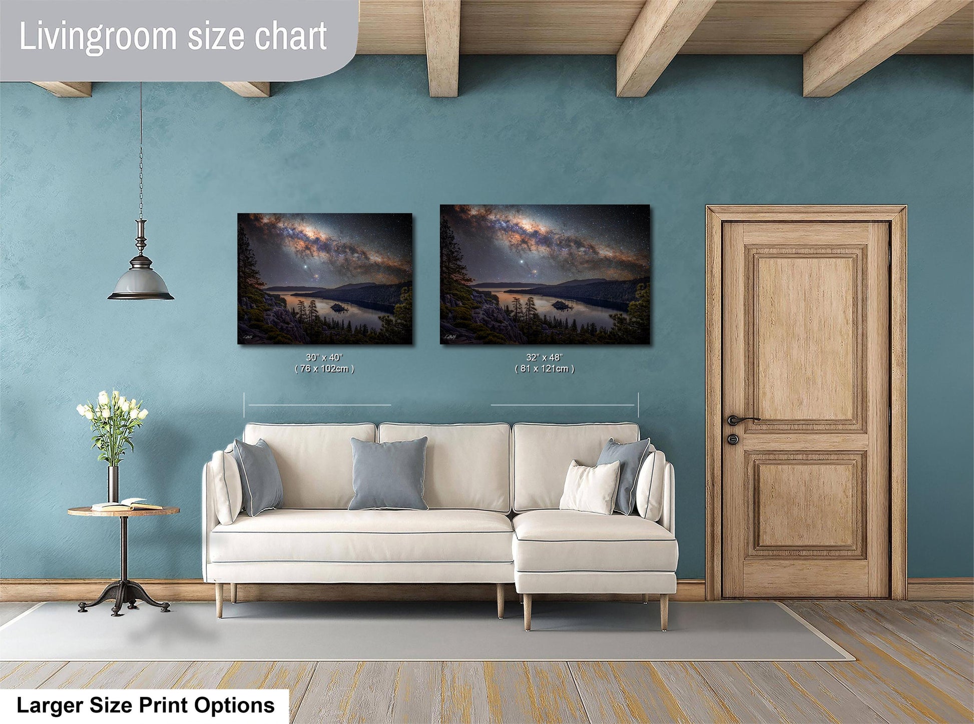 a living room with a white sofa, a wooden door, and two framed landscape paintings hanging on the wall.