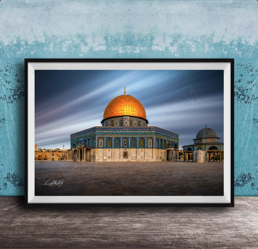 a large, ornate building with a golden dome, possibly a mosque or a significant historical structure, set against a blue sky with wispy clouds.