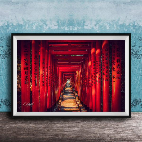 A framed photograph depicting a long, narrow red tunnel or walkway with Chinese characters on the walls, leading towards a light source at the end.