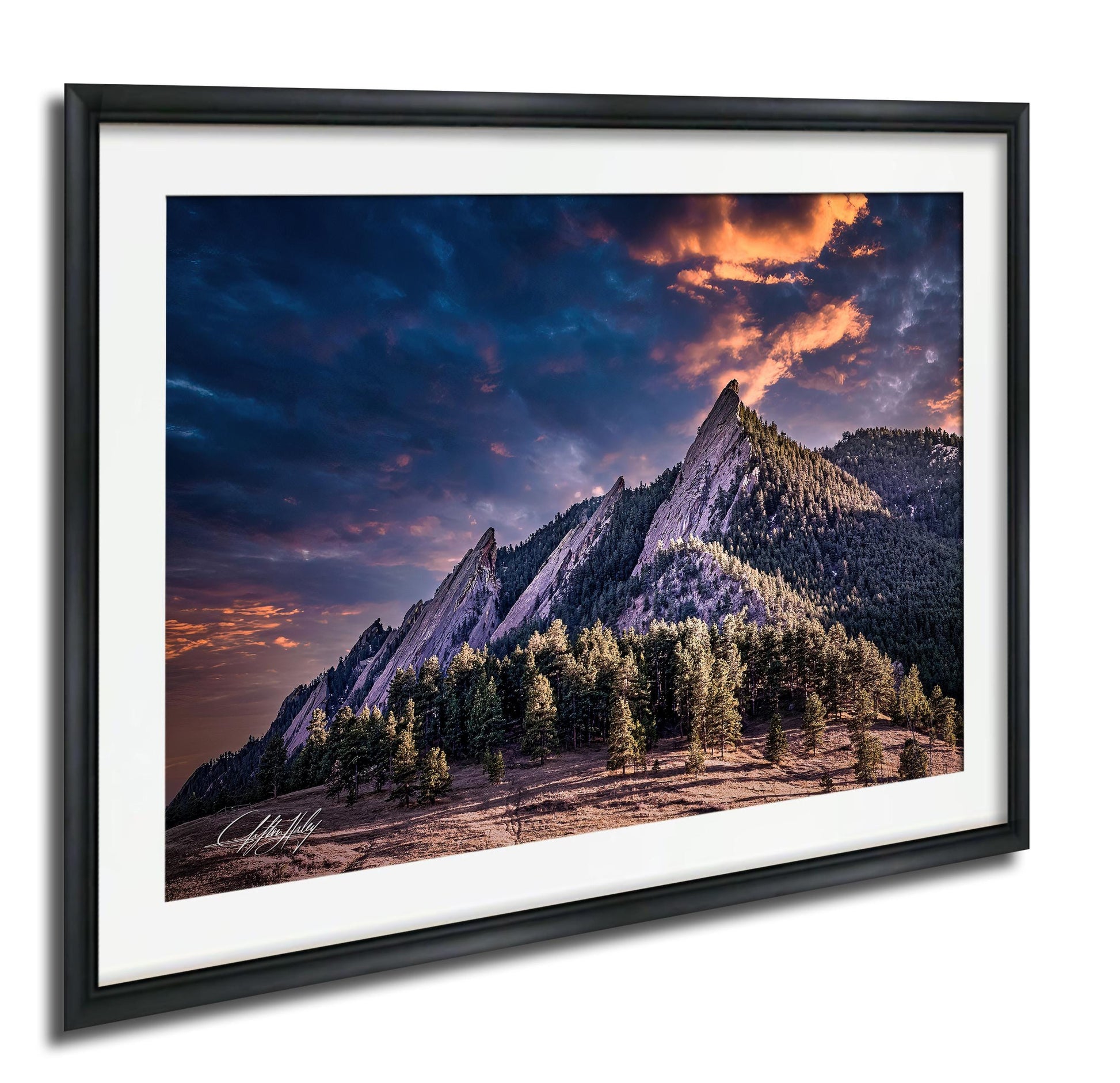 a breathtaking mountain landscape with a dramatic sky filled with clouds and vibrant colors, including shades of orange, blue, and purple. The mountains are covered in lush green trees, creating a serene and picturesque scene.