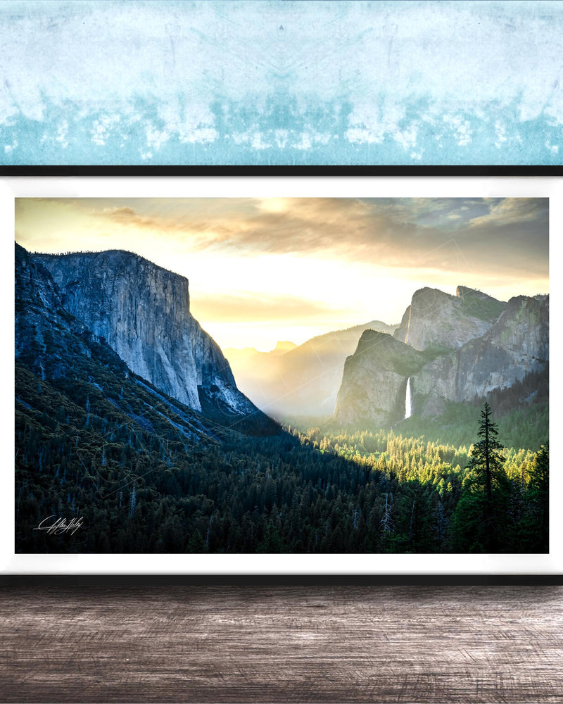 The image is a framed photograph of a scenic mountain landscape with a waterfall, set against a blue and white background.