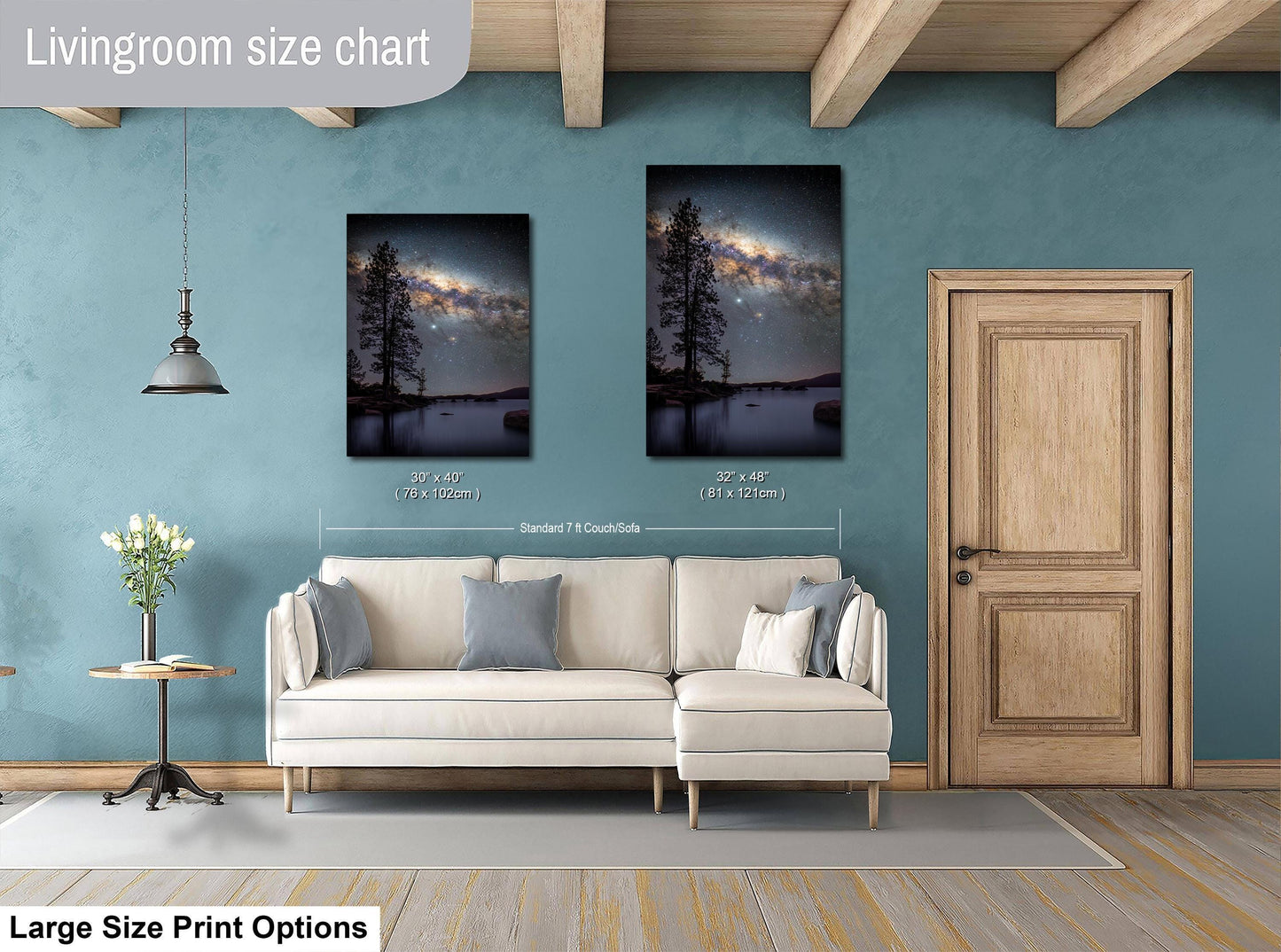 a living room with a white sofa, a wooden door, and two framed pictures of a night sky with a galaxy. The living room has a blue wall and a wooden ceiling.