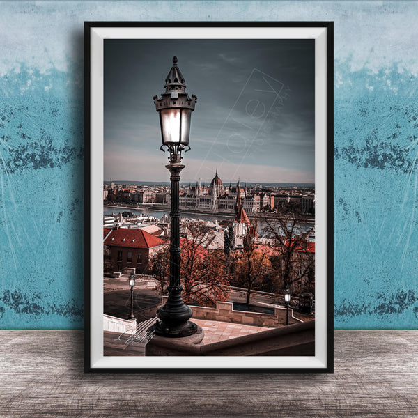 a cityscape with a tall street lamp in the foreground, overlooking the city.
