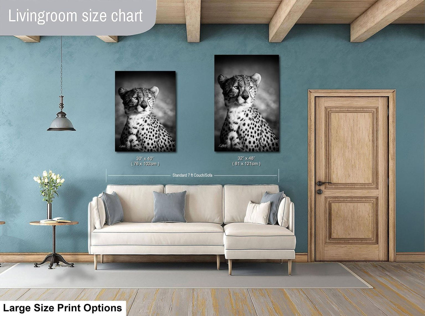 a living room with a white sofa and a wooden door. Above the sofa, there are two framed black and white photographs of a cheetah, which are hung on the wall. The living room has a blue wall and a wooden ceiling.