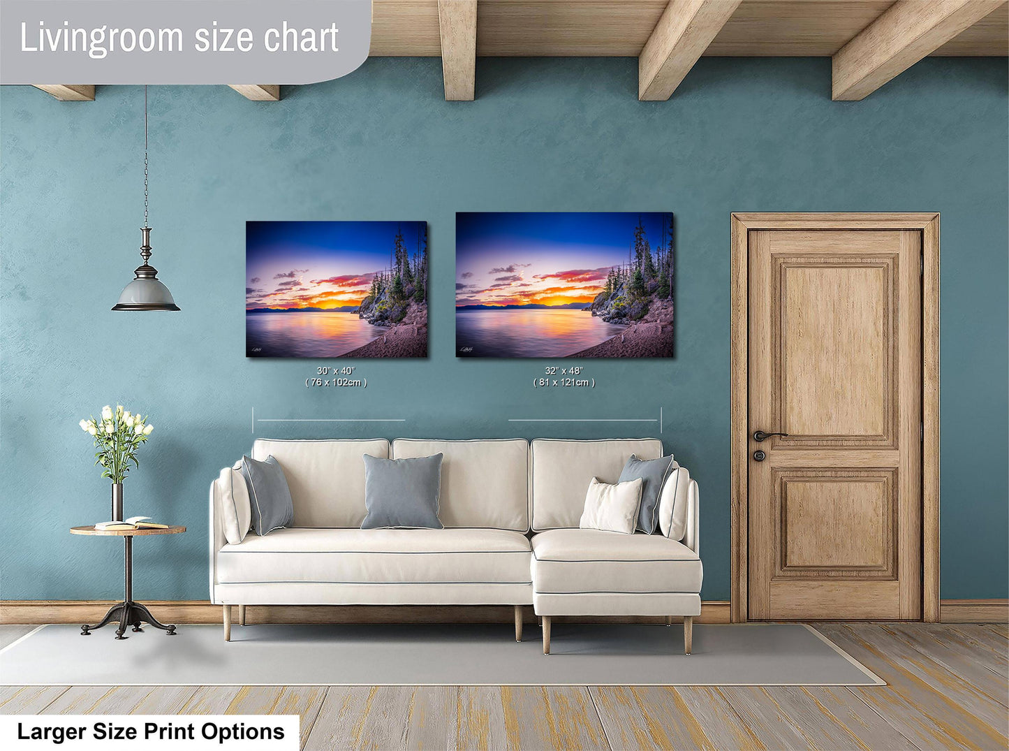 a living room with a white sofa and a wooden door. Above the sofa, there are two framed pictures of a sunset landscape, with one picture being larger than the other. The living room has a blue wall and a wooden ceiling.