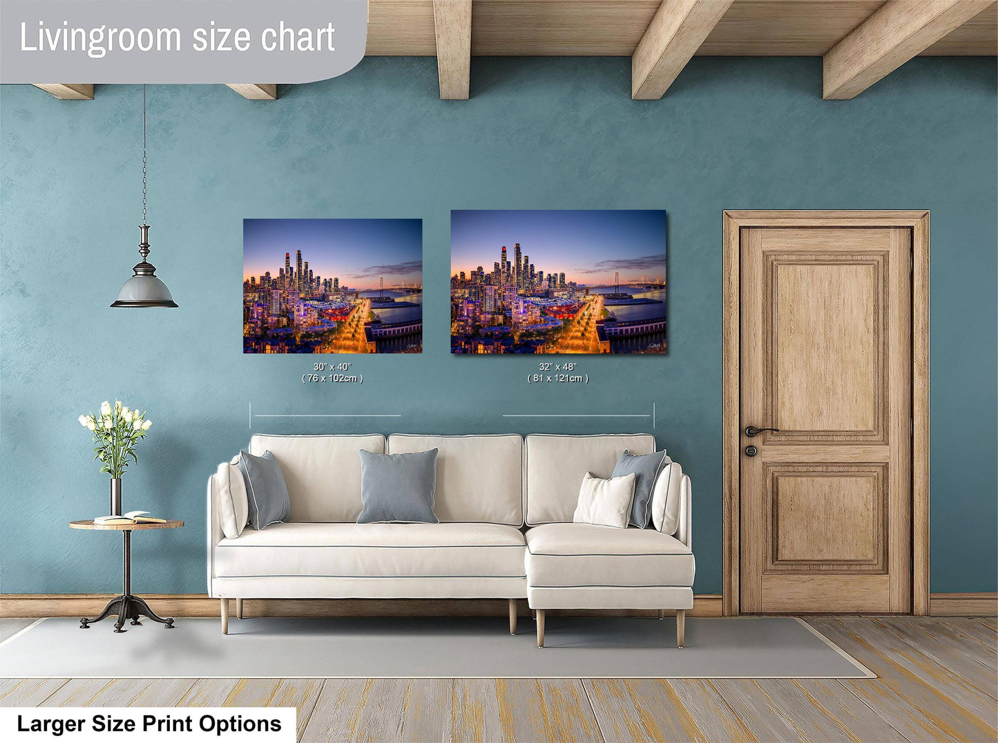 a living room with a white sofa and a wooden door. Above the sofa, there are two framed photographs of a city skyline at night, with the sizes of the photographs indicated as 30x42 inches and 31x42 inches.