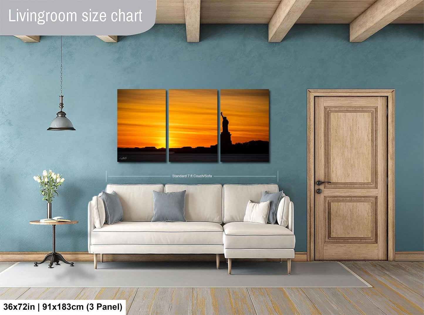 The image is a living room with a large wall art depicting a sunset over the Statue of Liberty. The room is furnished with a white sofa and a wooden door.