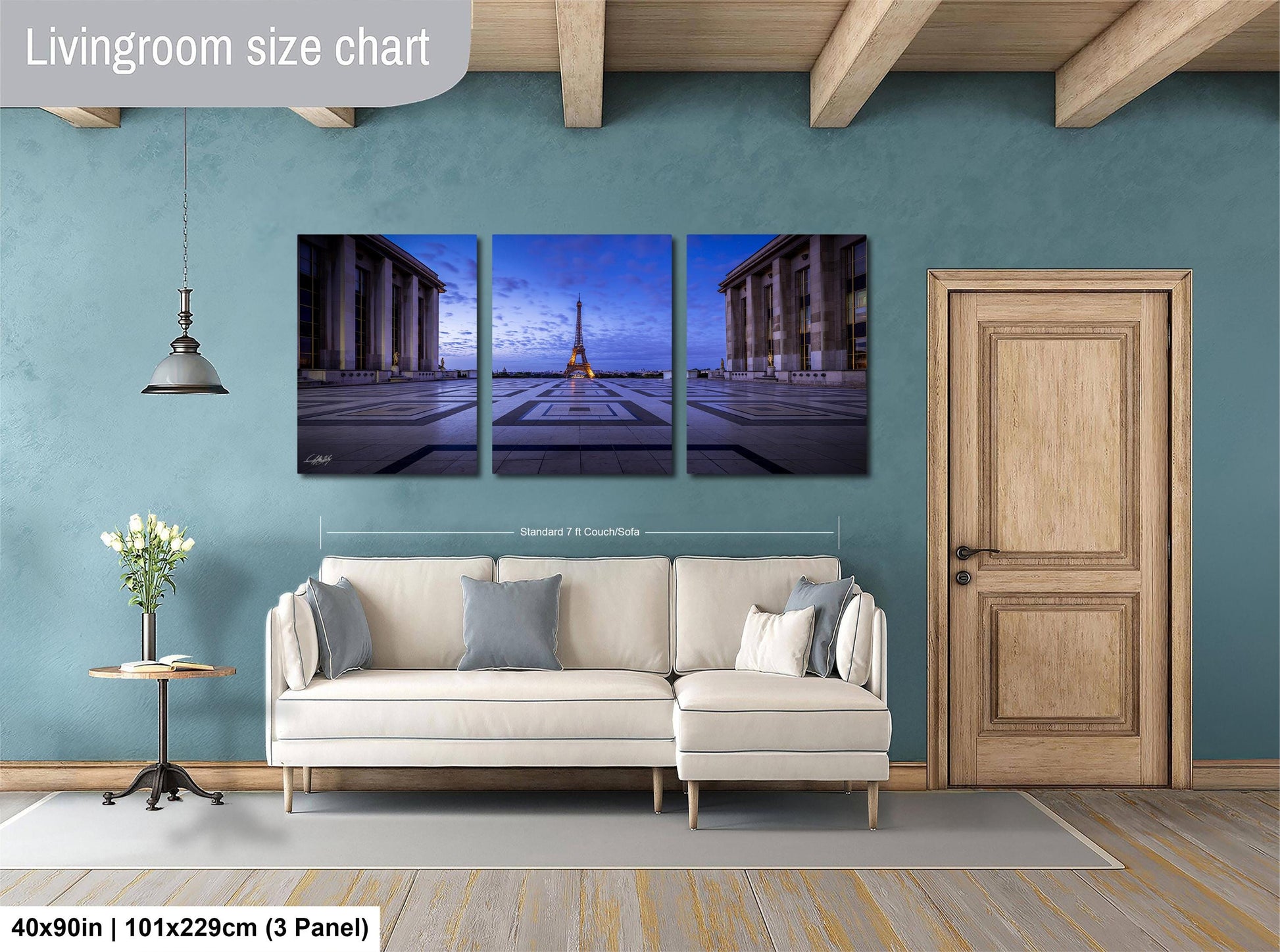 a living room with a couch and two paintings on the wall